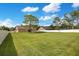 Large, well-maintained lawn with a mature shade tree and a full, white privacy fence at 5370 Knights Station Rd, Lakeland, FL 33810