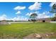 Generous backyard with a well-kept lawn, a shed, and a pristine white privacy fence at 5370 Knights Station Rd, Lakeland, FL 33810