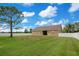 Spacious backyard featuring green grass, a mature tree, and a full privacy fence at 5370 Knights Station Rd, Lakeland, FL 33810