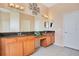 Bathroom featuring granite countertops, dual sinks, and bright lighting fixtures at 5370 Knights Station Rd, Lakeland, FL 33810