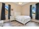 Bright bedroom with a bed, hardwood floors, and two windows at 5370 Knights Station Rd, Lakeland, FL 33810