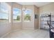 Cozy dining area featuring tiled flooring, views from bright windows, and decorative shelving at 5370 Knights Station Rd, Lakeland, FL 33810