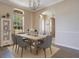 Bright dining room featuring a wooden table, gray chairs, and a view to the outside at 5370 Knights Station Rd, Lakeland, FL 33810