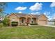 Charming single Gathering home with a well-manicured lawn and inviting front porch at 5370 Knights Station Rd, Lakeland, FL 33810