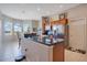 Bright kitchen featuring a breakfast bar, modern stainless steel appliances, and beautiful views at 5370 Knights Station Rd, Lakeland, FL 33810