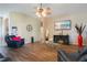 Comfortable living room featuring wood flooring, archways, and entertainment center with fireplace at 5370 Knights Station Rd, Lakeland, FL 33810