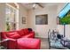 Inviting living room featuring stylish decor, a ceiling fan, and comfortable red seating at 5370 Knights Station Rd, Lakeland, FL 33810