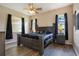 Relaxing main bedroom featuring stylish decor, a ceiling fan, and bright windows at 5370 Knights Station Rd, Lakeland, FL 33810