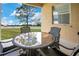 Covered patio featuring an outdoor dining set and view of a large backyard at 5370 Knights Station Rd, Lakeland, FL 33810