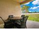 Covered patio featuring an outdoor dining set and view of a large backyard at 5370 Knights Station Rd, Lakeland, FL 33810