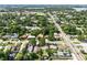 Scenic aerial shot of a verdant neighborhood showing tree coverage, streets, and various residences at 544 Avenue G Se, Winter Haven, FL 33880