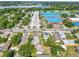 Aerial perspective of the neighborhood with a school and a lake nearby, showcasing houses among green trees at 544 Avenue G Se, Winter Haven, FL 33880