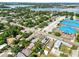Neighborhood aerial view with a lake in the distance, featuring well-kept houses, streets, and schools at 544 Avenue G Se, Winter Haven, FL 33880