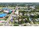 Aerial view of the neighborhood showcasing tree-lined streets and nearby schools and a body of water in the distance at 544 Avenue G Se, Winter Haven, FL 33880