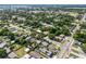 Aerial view showcasing houses amidst lush trees in a well-established neighborhood and sports fields at 544 Avenue G Se, Winter Haven, FL 33880