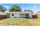Expansive backyard showing patio and building exterior with a full perimeter fence at 544 Avenue G Se, Winter Haven, FL 33880