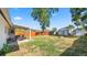 Spacious backyard featuring a covered patio, two storage sheds and a fire pit at 544 Avenue G Se, Winter Haven, FL 33880