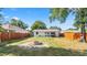 Large, fenced backyard with fire pit, offering ample outdoor space and privacy at 544 Avenue G Se, Winter Haven, FL 33880