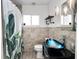 Updated bathroom with modern fixtures, vessel sink, decorative tile, and tub with shower at 544 Avenue G Se, Winter Haven, FL 33880