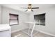 Bedroom featuring a white bunk bed, ceiling fan, wood-look flooring, and lots of light from two windows at 544 Avenue G Se, Winter Haven, FL 33880