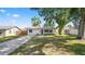Quaint single-story home with a long driveway and a shady front yard at 544 Avenue G Se, Winter Haven, FL 33880
