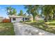 Pleasant single-story home with a spacious driveway and a lush, green front yard at 544 Avenue G Se, Winter Haven, FL 33880