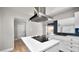 Modern kitchen with stainless steel hood vent and white cabinets at 544 Avenue G Se, Winter Haven, FL 33880