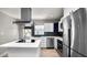 Bright kitchen featuring stainless steel appliances, white cabinets and an island cooktop at 544 Avenue G Se, Winter Haven, FL 33880