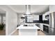 Modern kitchen featuring stainless steel appliances, a center island, and blue backsplash at 544 Avenue G Se, Winter Haven, FL 33880