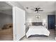 Bedroom with tiled floors, ceiling fan, neutral walls, and an ensuite bathroom at 544 Avenue G Se, Winter Haven, FL 33880