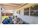 Cozy patio area with blue cushioned seating, perfect for relaxing outside with grass yard views at 544 Avenue G Se, Winter Haven, FL 33880