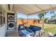 Back patio features modern seating, outdoor lighting, and a convenient washer/dryer setup at 544 Avenue G Se, Winter Haven, FL 33880