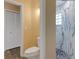Bathroom featuring a tiled shower, white toilet, closet and yellow painted walls at 5722 Antler Trl, Lakeland, FL 33811