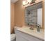 Bathroom featuring modern white vanity and marble tiled shower at 5722 Antler Trl, Lakeland, FL 33811