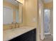 Bathroom with marble countertop vanity, decorative mirror and a tiled shower in the next room at 5722 Antler Trl, Lakeland, FL 33811