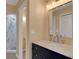 Updated bathroom features a granite vanity, a custom mirror, and a tiled shower at 5722 Antler Trl, Lakeland, FL 33811