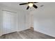 A bedroom with gray floors, white walls, a ceiling fan and a closet at 5722 Antler Trl, Lakeland, FL 33811