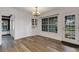 Dining Room featuring large window, modern chandelier and adjacent access to tiled sun room at 5722 Antler Trl, Lakeland, FL 33811