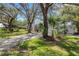 Single Gathering home featuring mature landscaping and driveway at 5722 Antler Trl, Lakeland, FL 33811