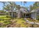 A charming single-Gathering home with a brick chimney, lush green lawn, and mature landscaping at 5722 Antler Trl, Lakeland, FL 33811