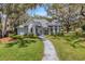 Charming single-story home featuring a turret, inviting entryway, and mature landscaping at 5722 Antler Trl, Lakeland, FL 33811