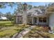 Charming home exterior with mature landscaping, brick chimney, and sidewalk at 5722 Antler Trl, Lakeland, FL 33811