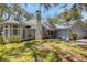 A charming single-Gathering home with a brick chimney and lush green lawn at 5722 Antler Trl, Lakeland, FL 33811
