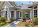 Charming home entrance with a walkway, a decorative glass front door, and lush landscaping at 5722 Antler Trl, Lakeland, FL 33811