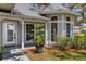 A beautifully landscaped home entrance featuring a decorative glass front door and inviting curb appeal at 5722 Antler Trl, Lakeland, FL 33811