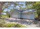 Light blue three-car garage with white doors on a paved driveway at 5722 Antler Trl, Lakeland, FL 33811