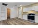 Kitchen and adjoining rooms featuring updated flooring and adjacent bathroom access at 5722 Antler Trl, Lakeland, FL 33811