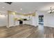 Open kitchen featuring white cabinets, stainless steel appliances, and wood-look flooring at 5722 Antler Trl, Lakeland, FL 33811