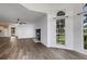 Open-concept living space with wood-look floors, a fireplace, and plenty of natural light at 5722 Antler Trl, Lakeland, FL 33811