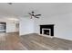 Bright living room featuring a fireplace, fan, and contemporary wood-look flooring at 5722 Antler Trl, Lakeland, FL 33811